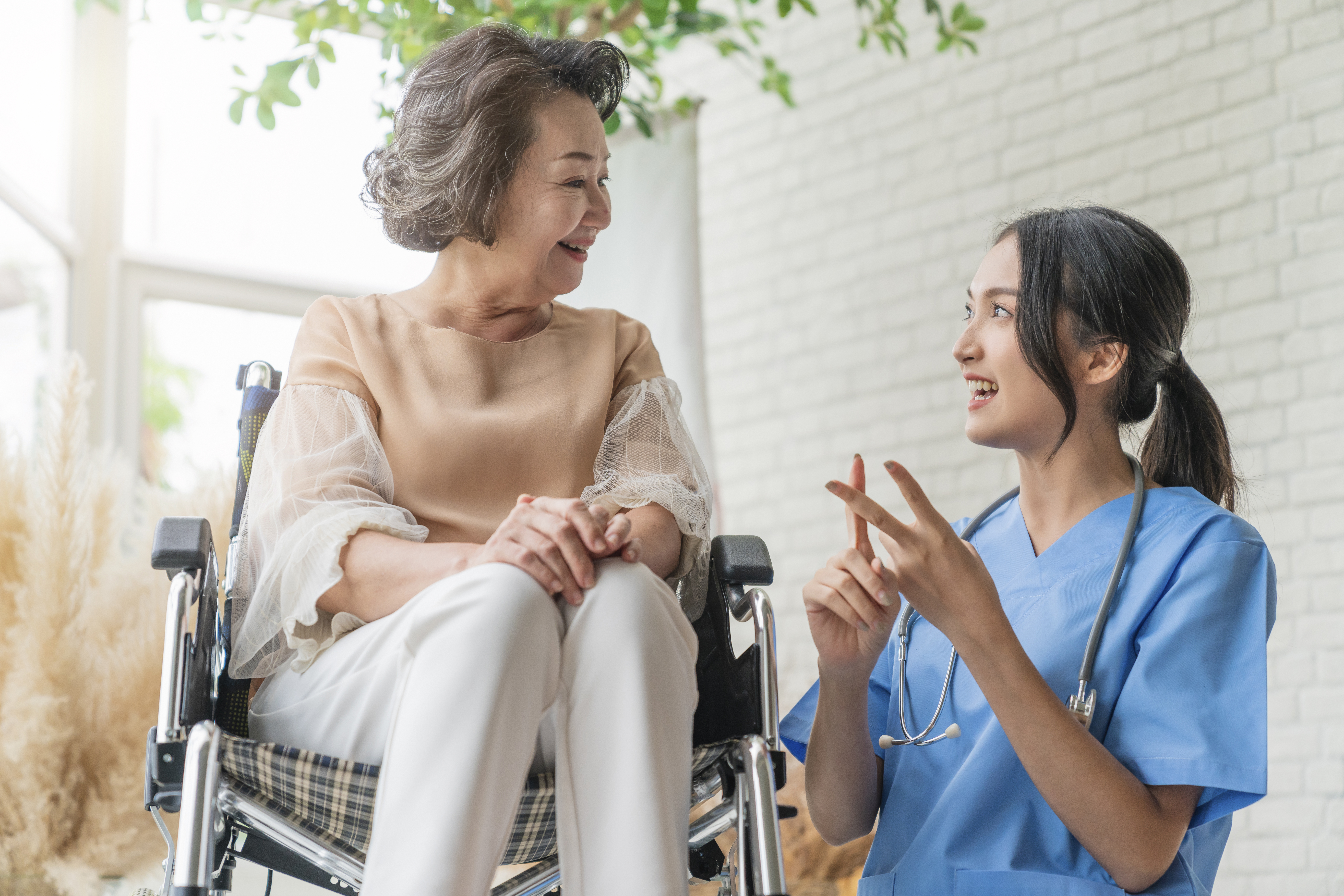 https://img.moneyduck.com/article_attachment/1661308323-asian-young-caregiver-caring-her-elderly-patient-senior-daycare-handicap-patient-wheelchair-hospital-talking-friendly-nurse-looking-cheerful-nurse-wheeling-senior-patient.jpg