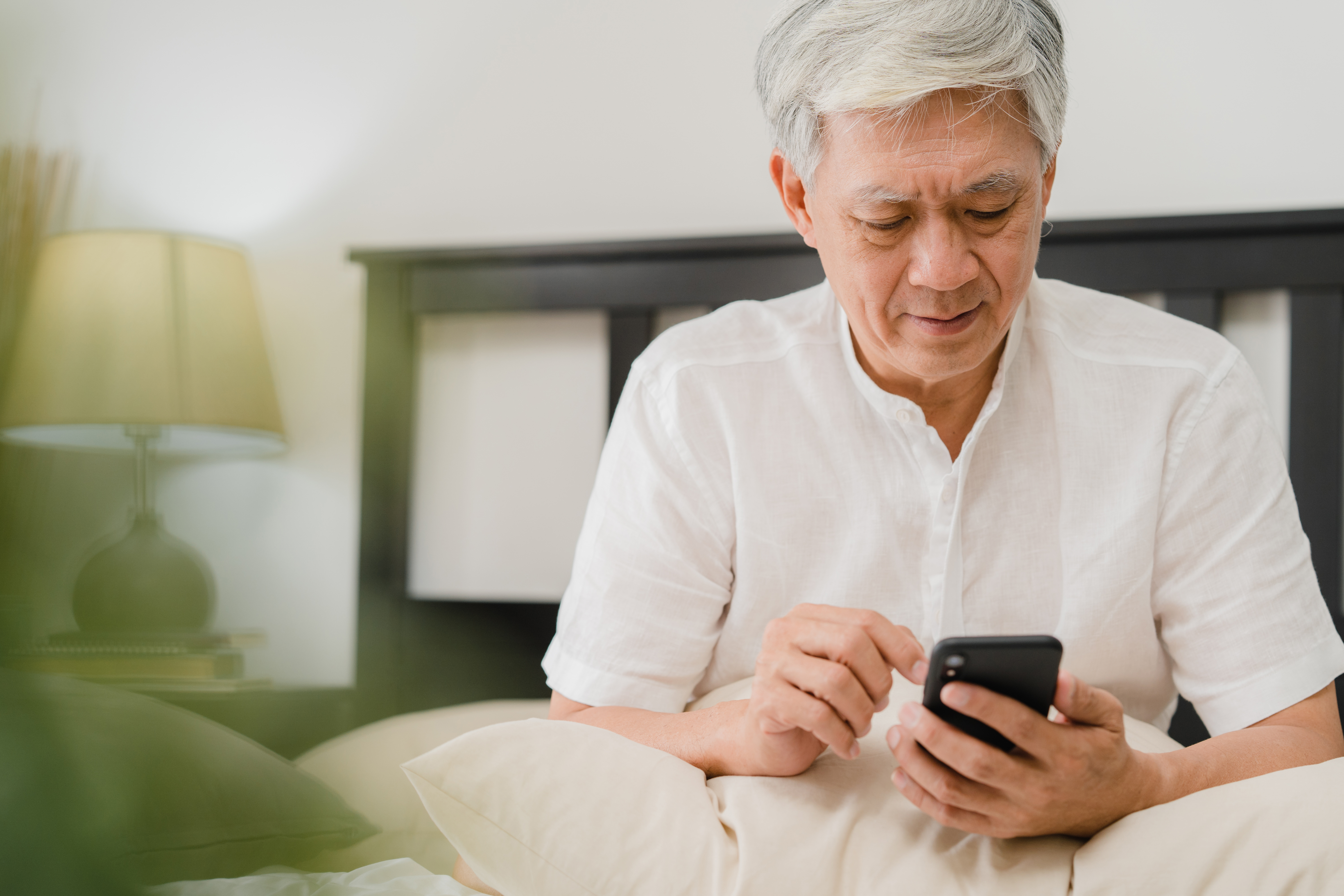 https://img.moneyduck.com/article_attachment/1671171896-asian-senior-men-using-mobile-phone-home-asian-senior-chinese-male-search-information-about-how-good-health-internet-while-lying-bed-bedroom-home-morning-concept.jpg