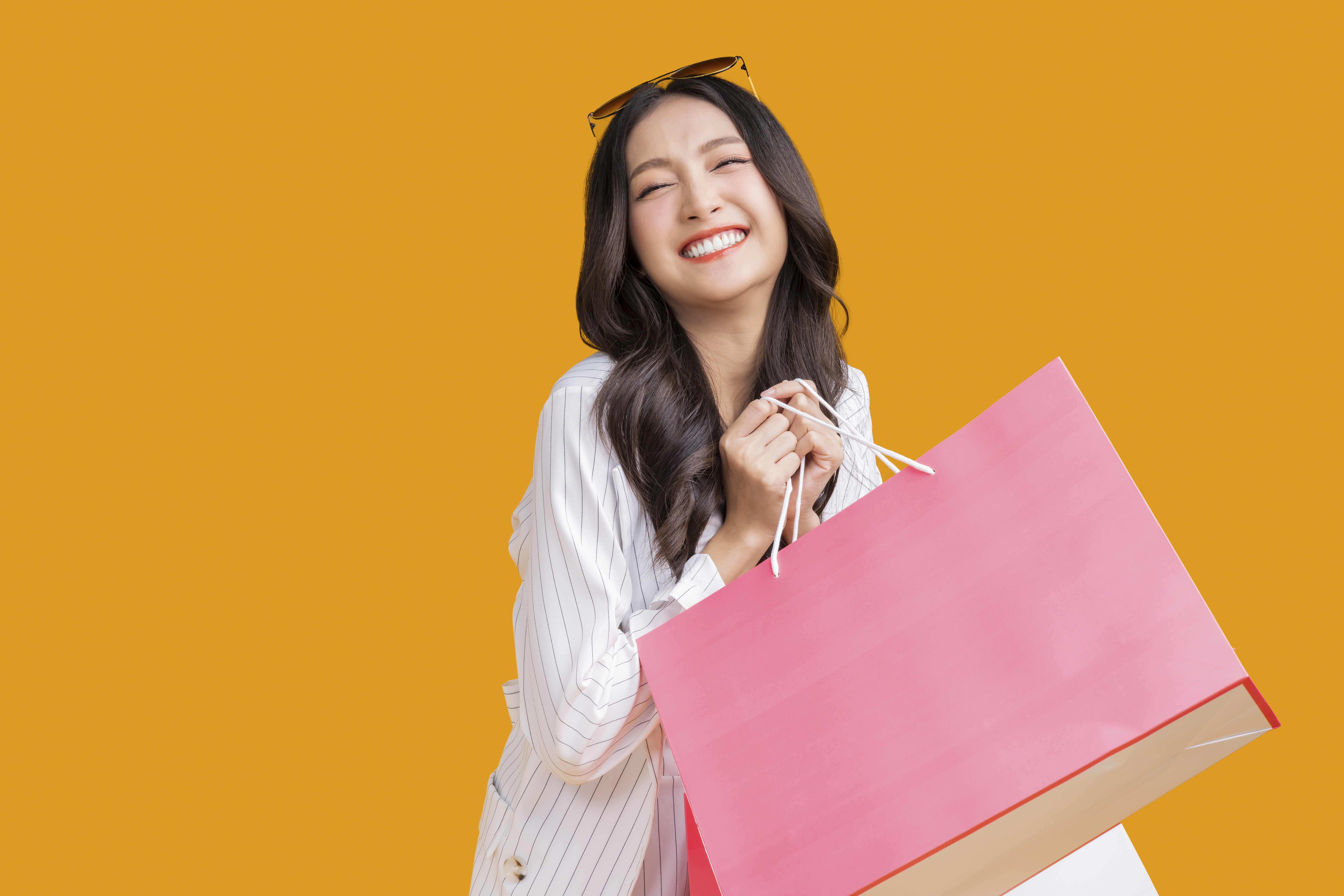 https://img.moneyduck.com/article_attachment/1675408385-asian-happy-female-woman-girl-holds-colourful-shopping-packages-standing-yellow-background-studio-shot-close-up-portrait-young-beautiful-attractive-girl-smiling-looking-camera-with-bags.jpg