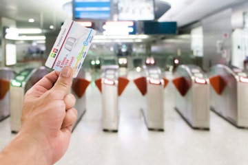 Stock Photo - 25-February 2018 Passenger holding ticket at the entrance at Singapore MRT station